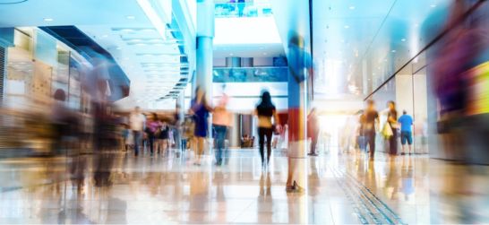 crowds of people walking in a mall